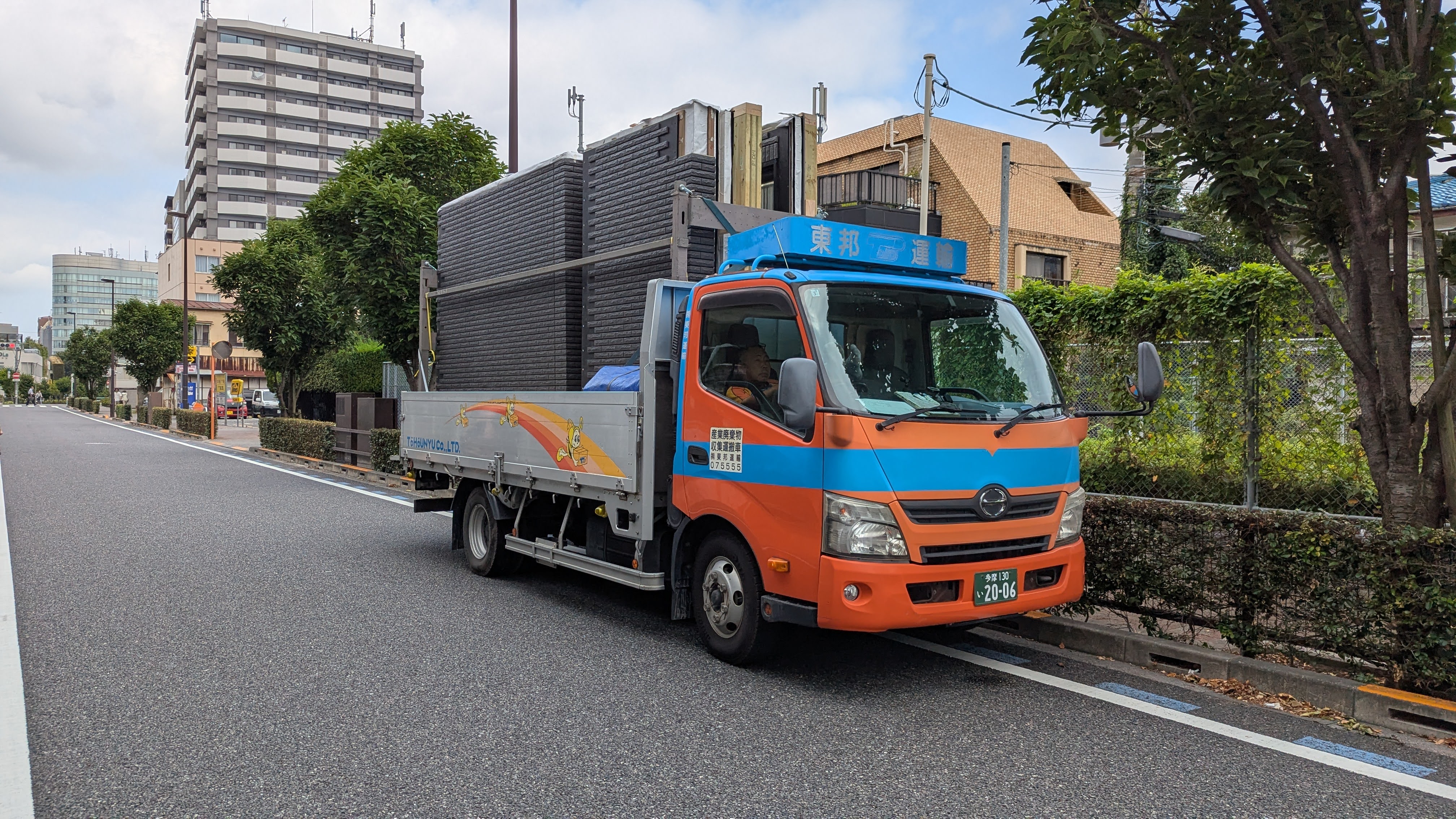 Parts of an Ichijo house on a truck, waiting to be assembled